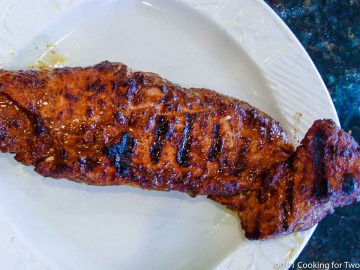 cooked pork tenderloin on a white plate