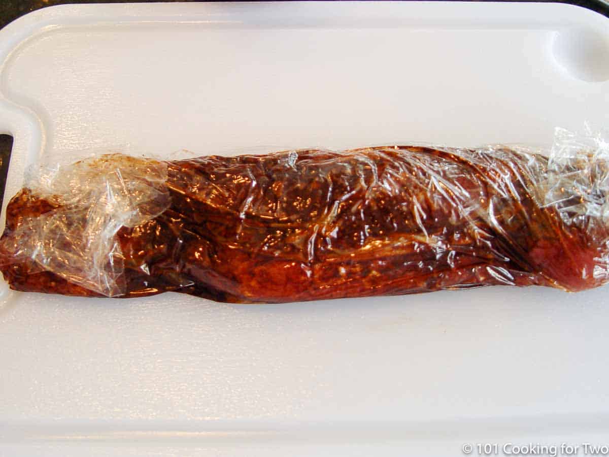 honey pork tenderloin in plastic wrap
