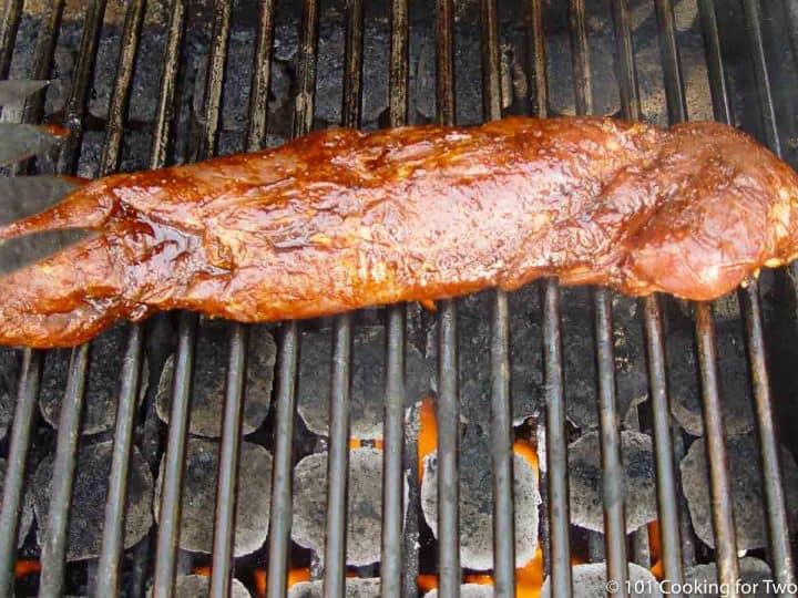 placing the pork tenderloin on the grill