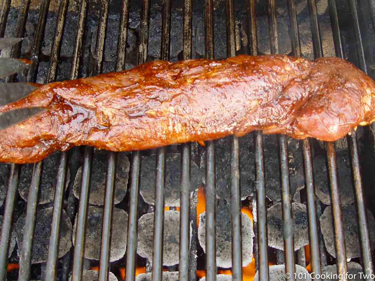 placing the pork tenderloin on the grill