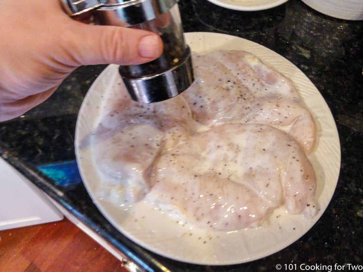 adding pepper to milk coverd chicken.