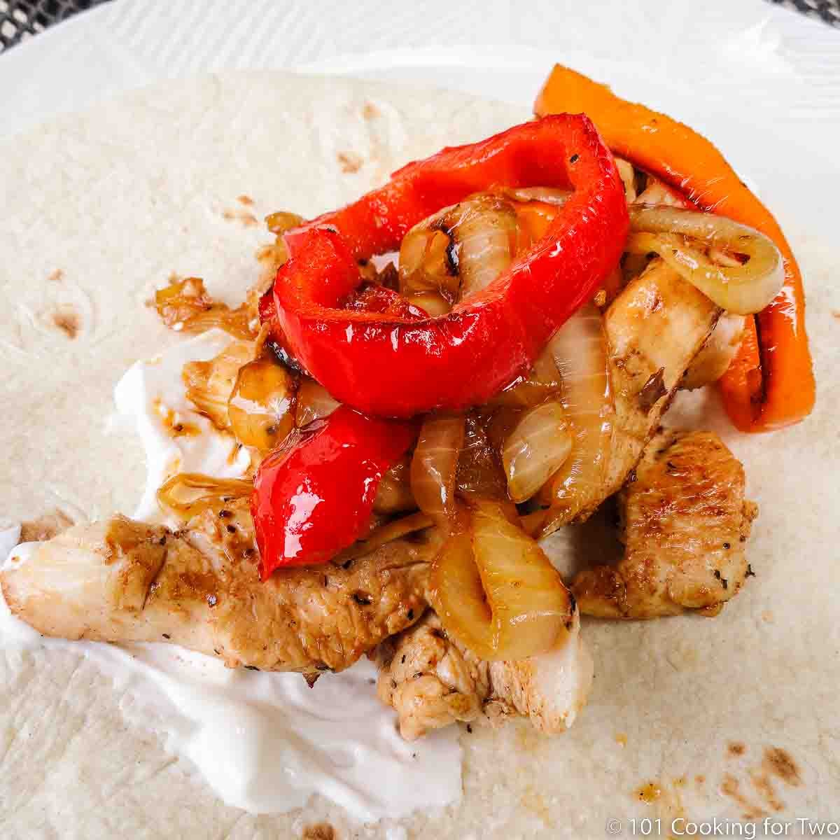 chicken fajitas on tortilla.