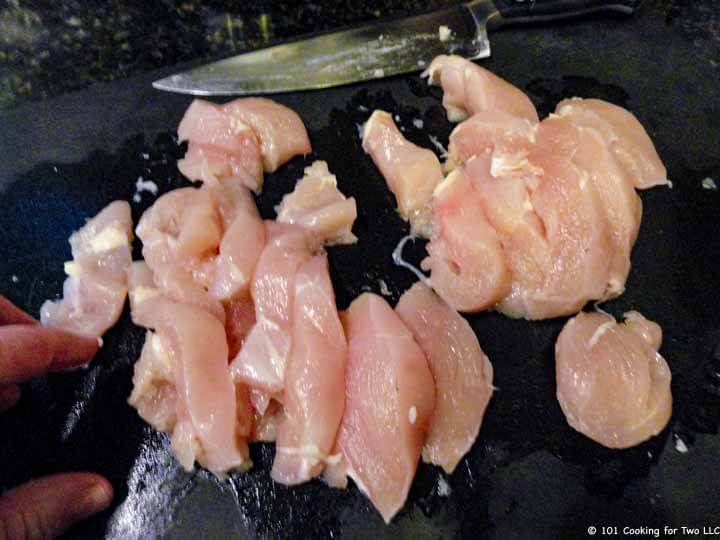 trim chicken breasts into strips,