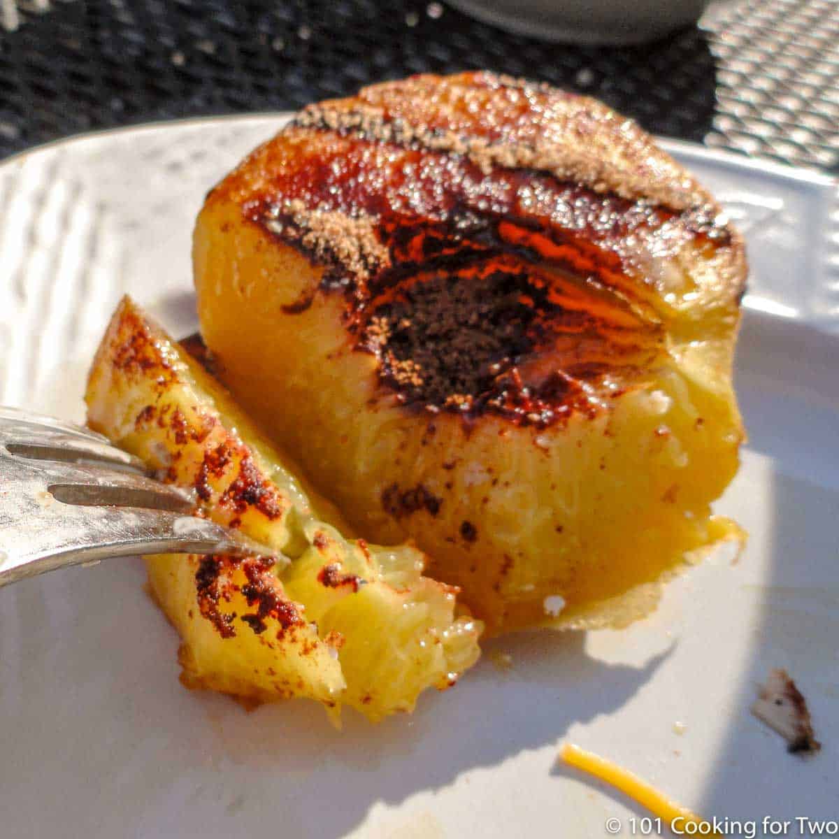 grilled peach on a white plate