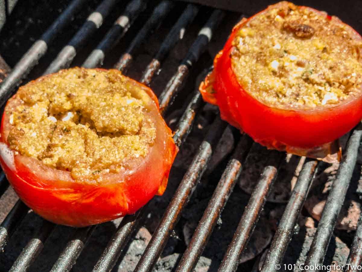 grilled tomato browning on grill grates.