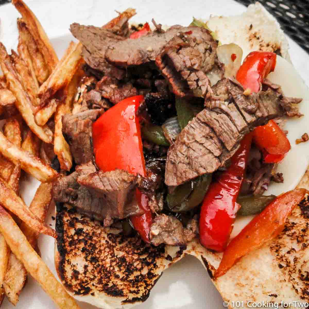 Philly sandwich on plate with fries
