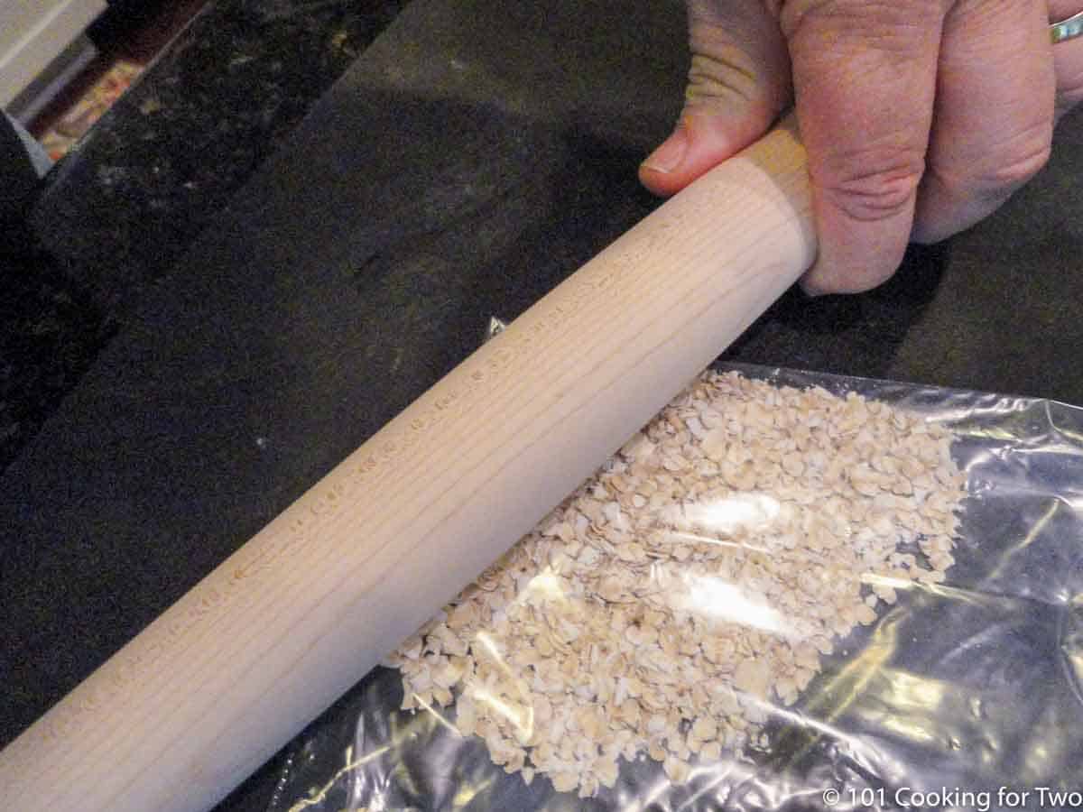 crushing oats with rolling pin