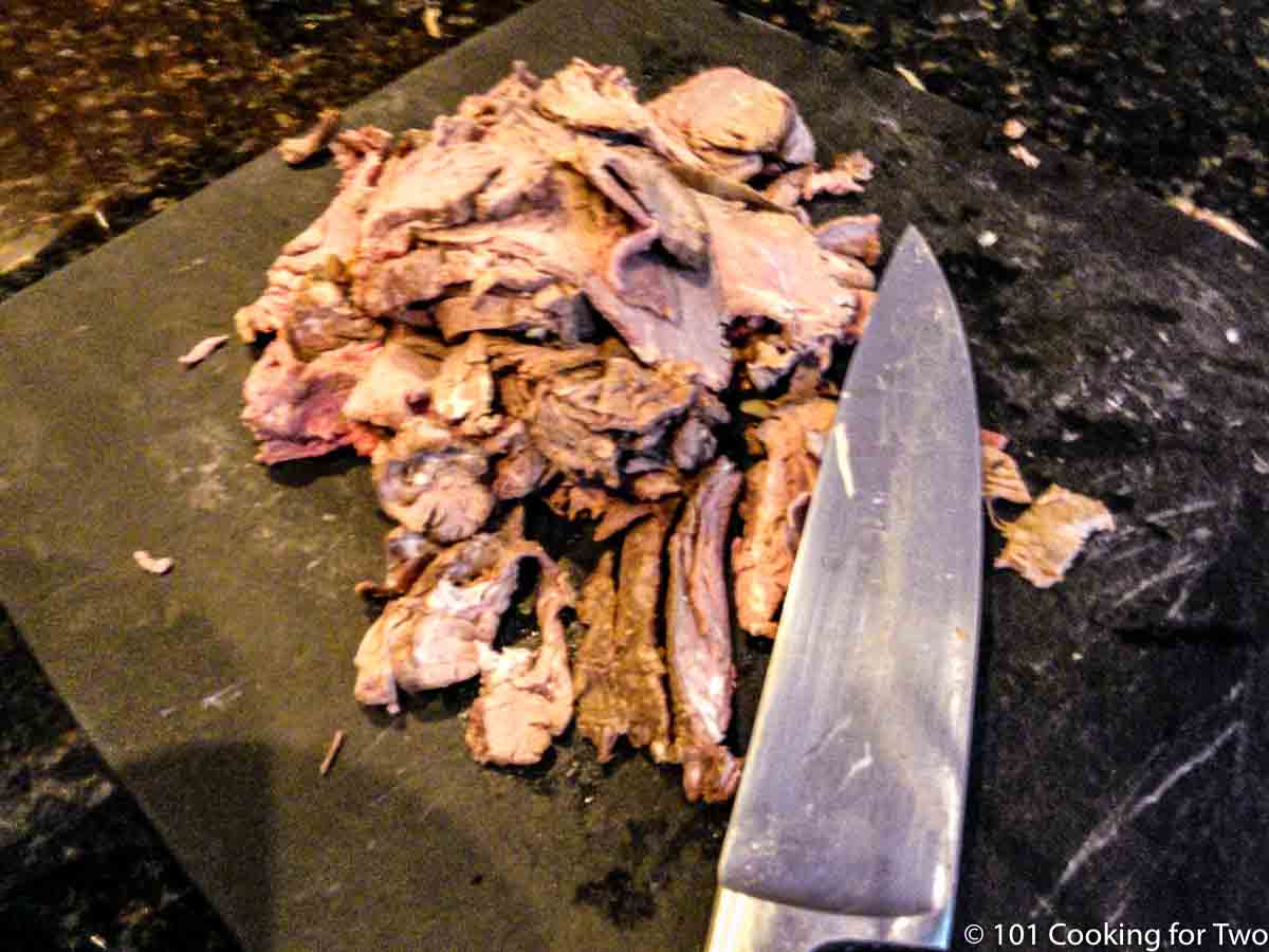 cut up beef on a black board