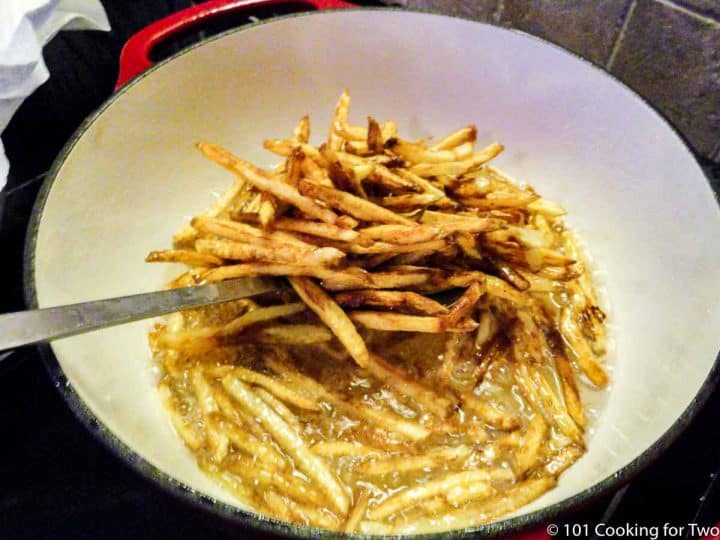 scooping fries out of oil