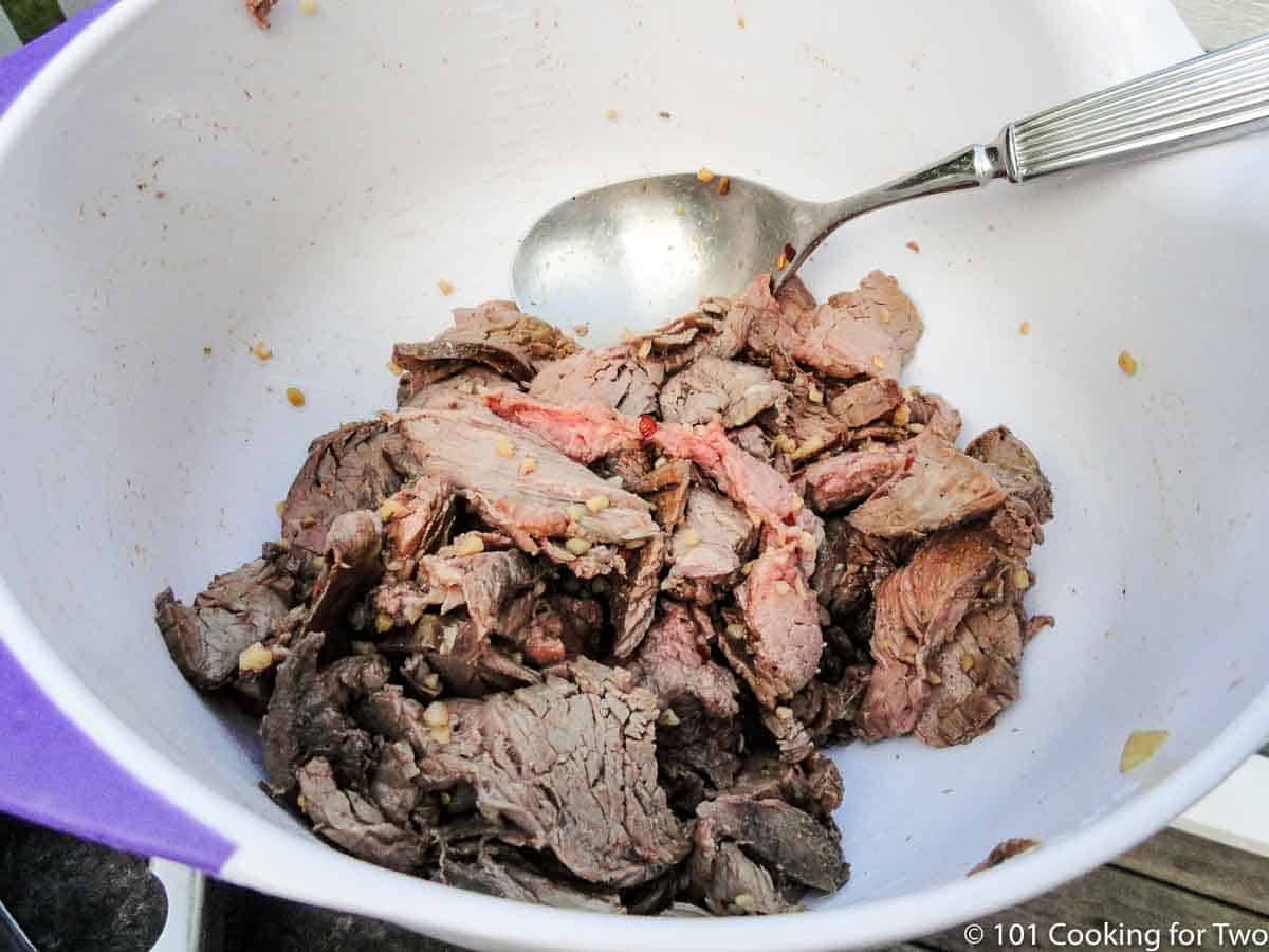 seasoning beef in white bowl