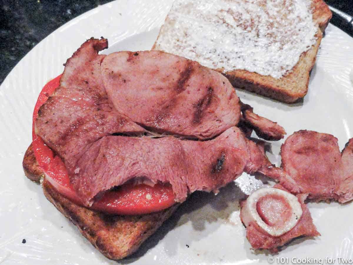 grilled ham on toast and a white plate