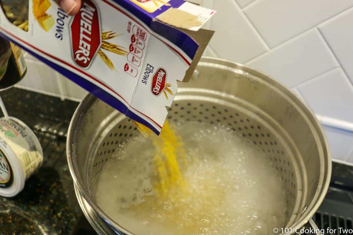 adding elbow pasta to boiling water