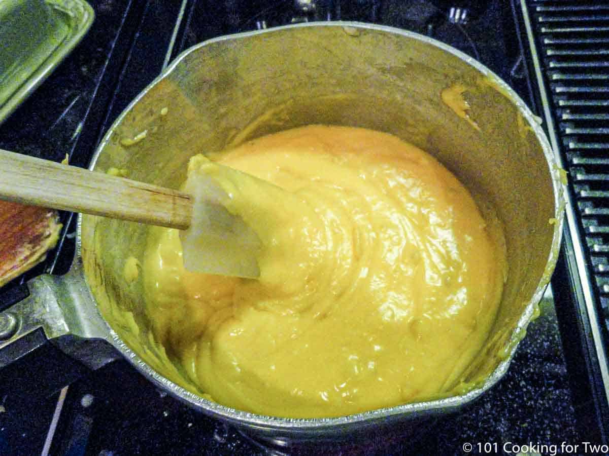 mixing cheese sauce in pan
