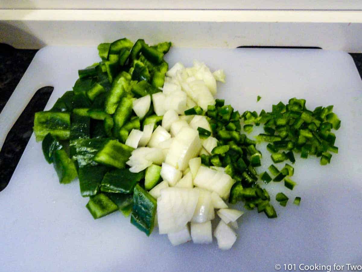 chopped vegetables on white board.