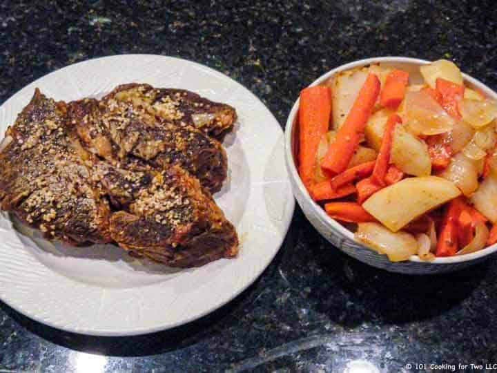 pot roast on plate and veggies in bowl