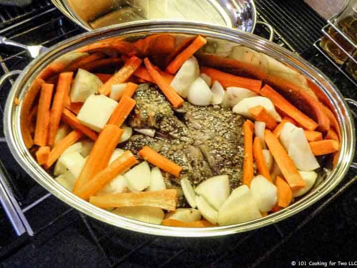 raw veggies added to roaster with meat