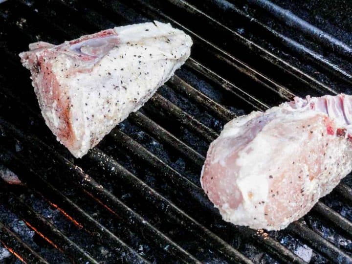 pieces of chicken breasts on a grill