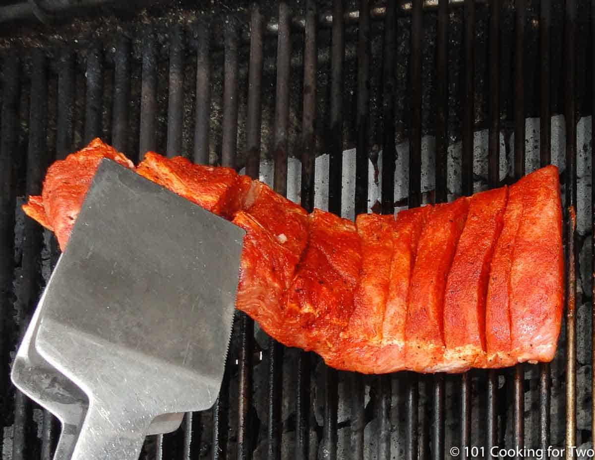 placing boneless ribs on grill