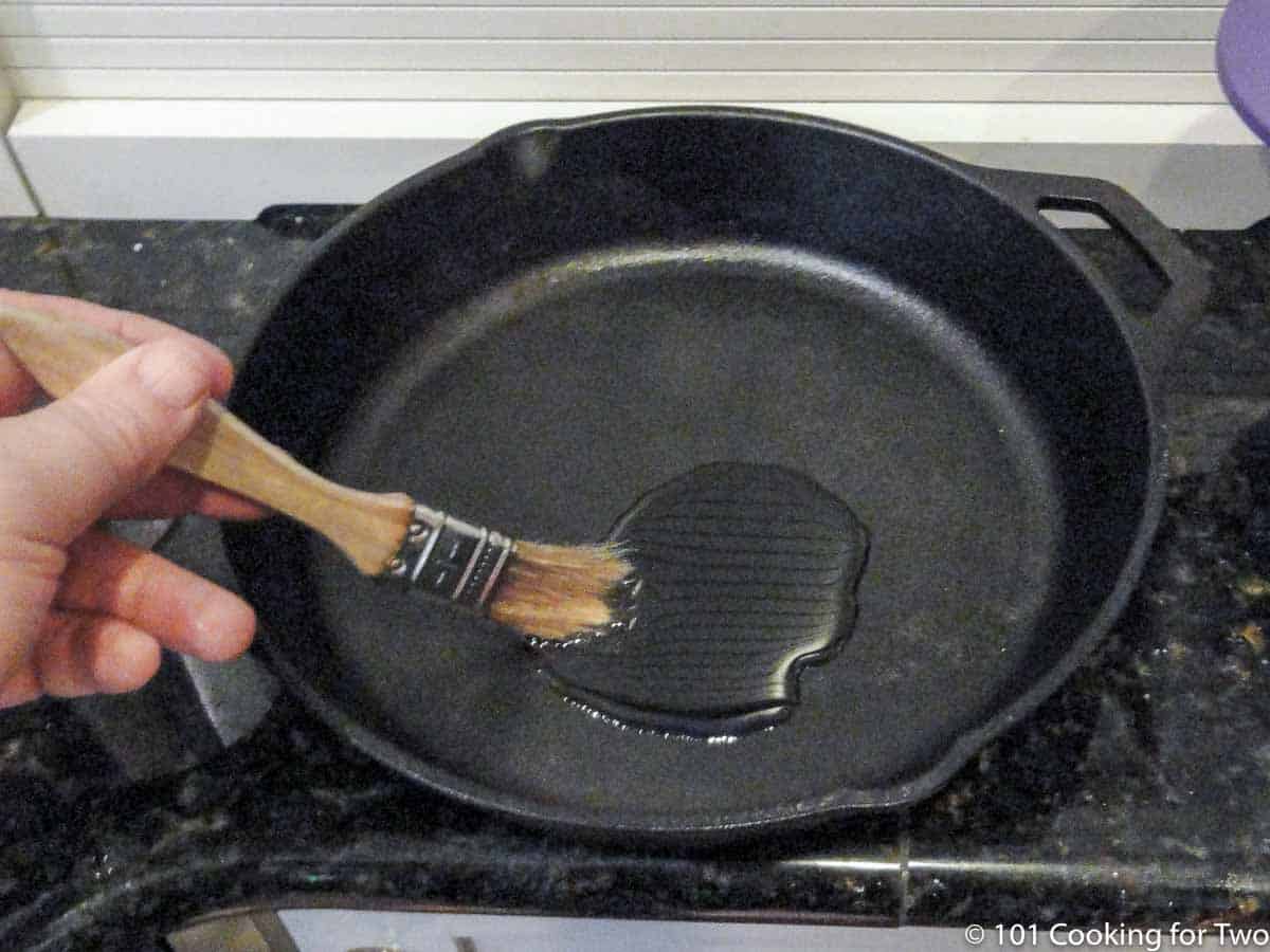 brushing oil coating in a cast iron pan.