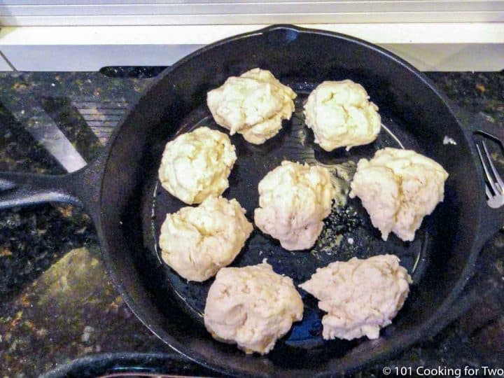 eight raw biscuits in a cast iron pan
