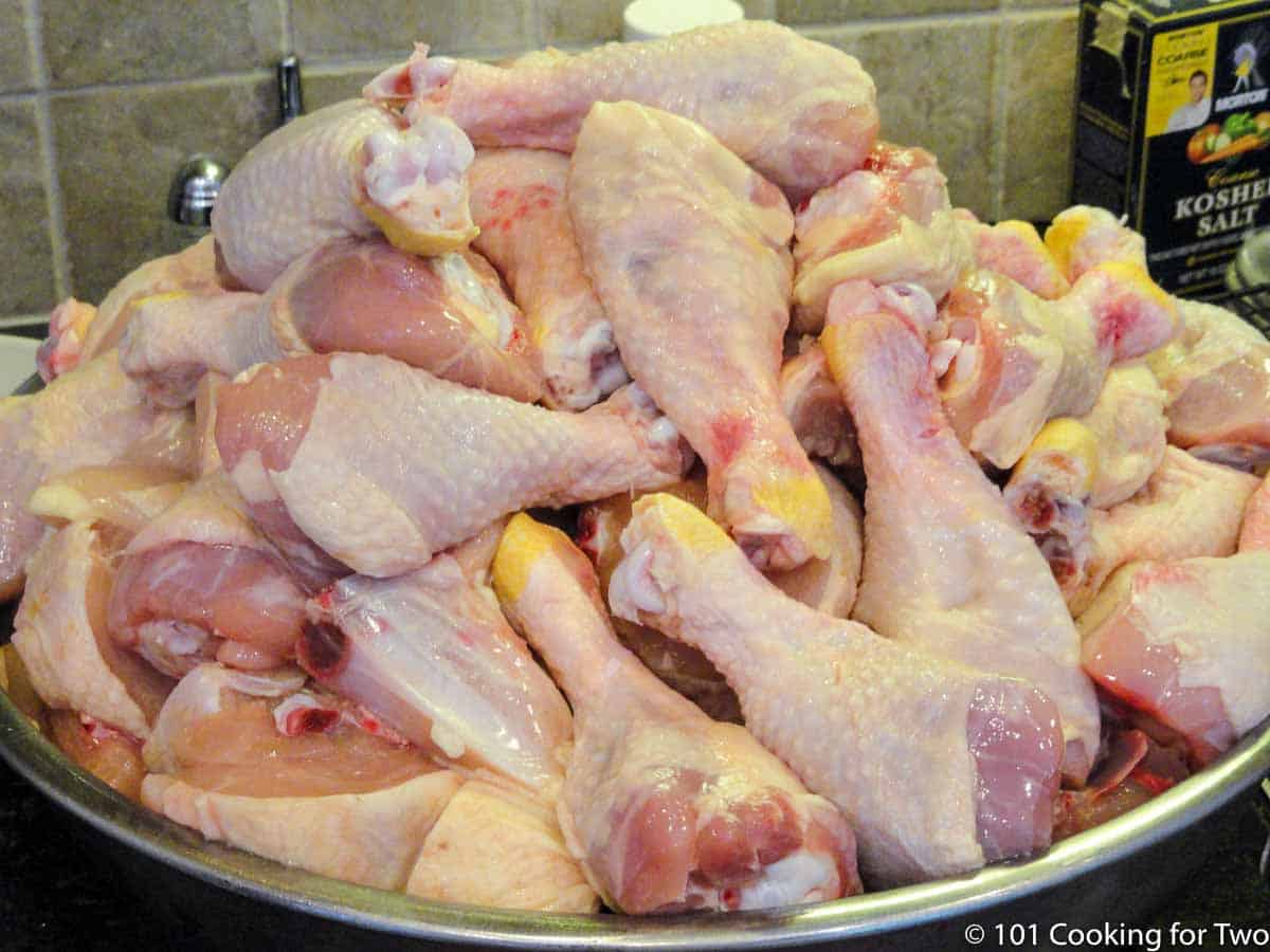 Large bowl full of trimmed chicken.