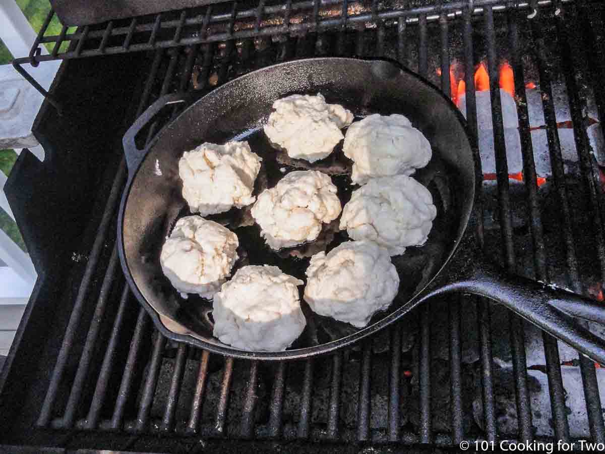 skillet with biscuits on grill.