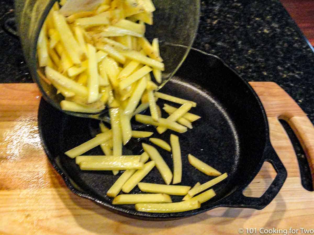 adding fries to grill pan