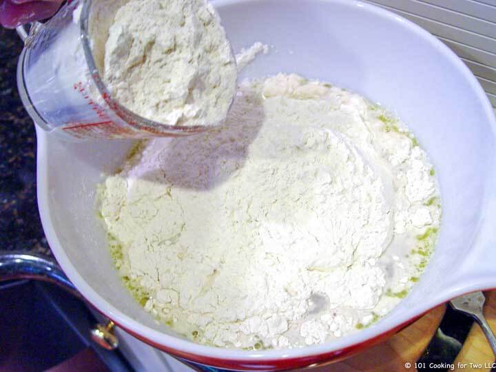 adding flour to bowl