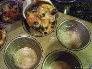 adding muffin dough to pan