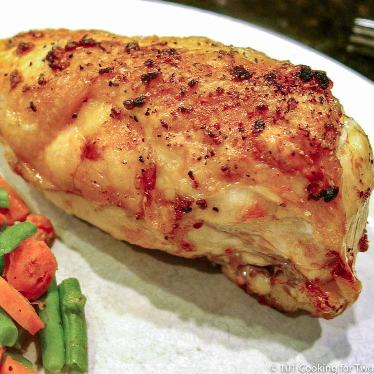 chicken breast on white plate.