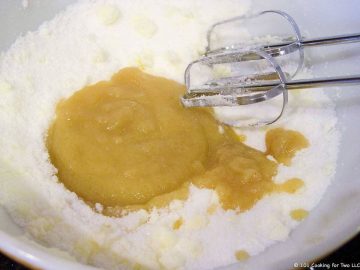 Mixing sugar and applesauce in bowl with mixer