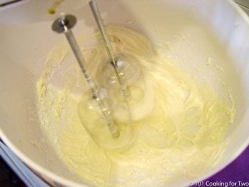mixing frosting in white bowl