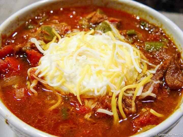 Texas Chili with sour cream and cheese in bowl