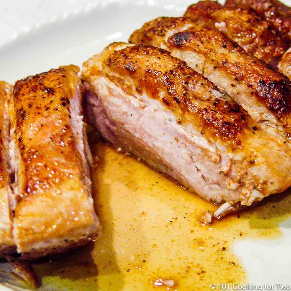 boneless pork ribs cut on white plate.