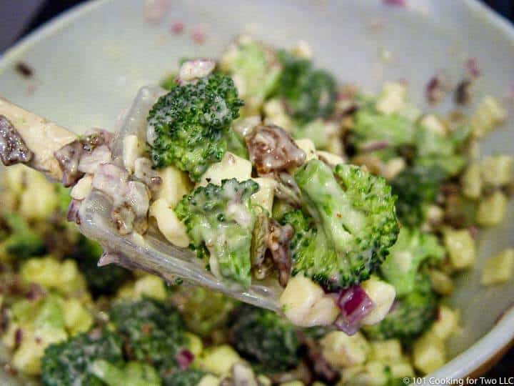 mixing broccoli salad