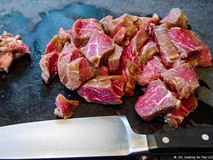 trimmed steak cubes on board.