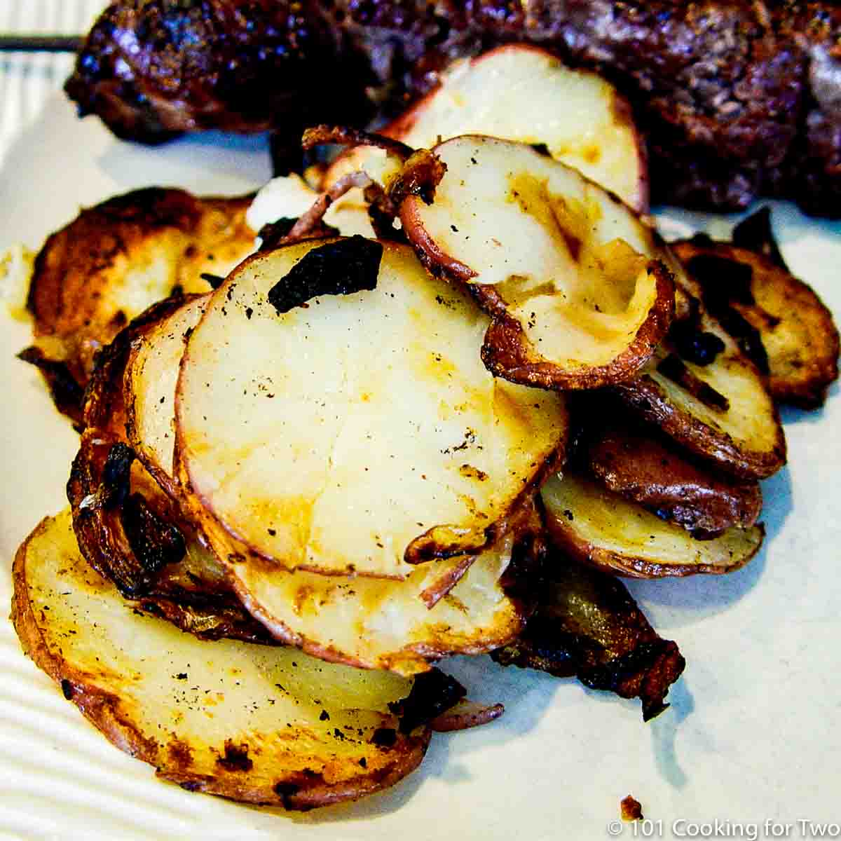 image of grill potato slice on a white plate.