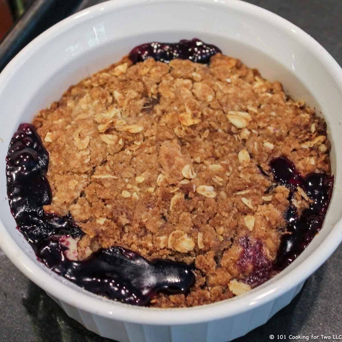 blueberry crisp in white bowl.