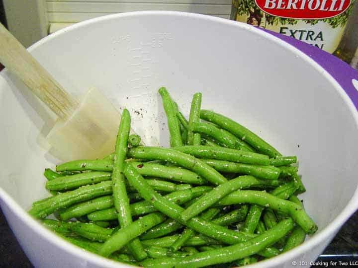 mixing beans with oil in bowl