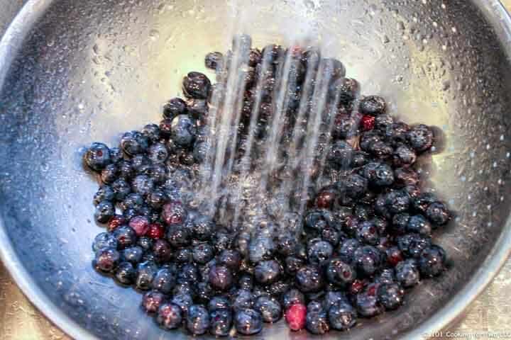 rinsing berries under running water.