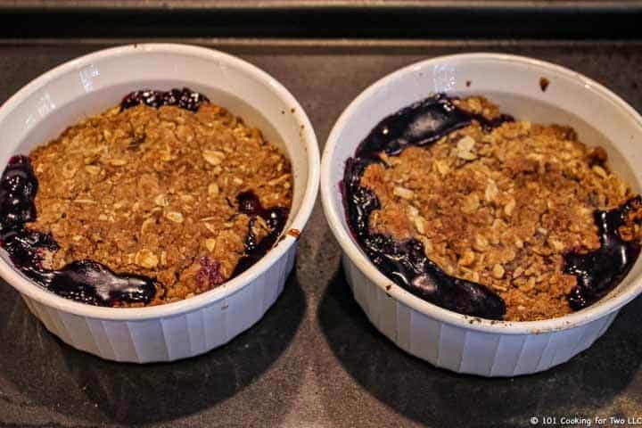 two bowls with cooked berry crisp