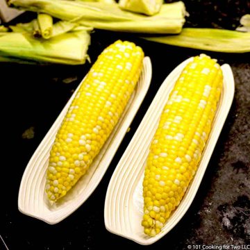 two ears of corn in trays