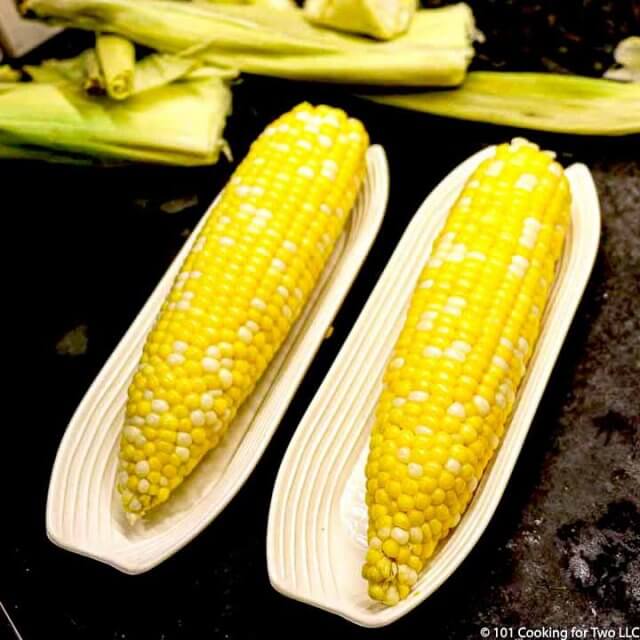 two ears of corn in trays
