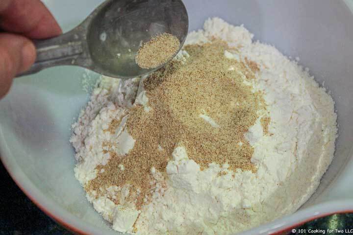 adding spices to flour in bowl