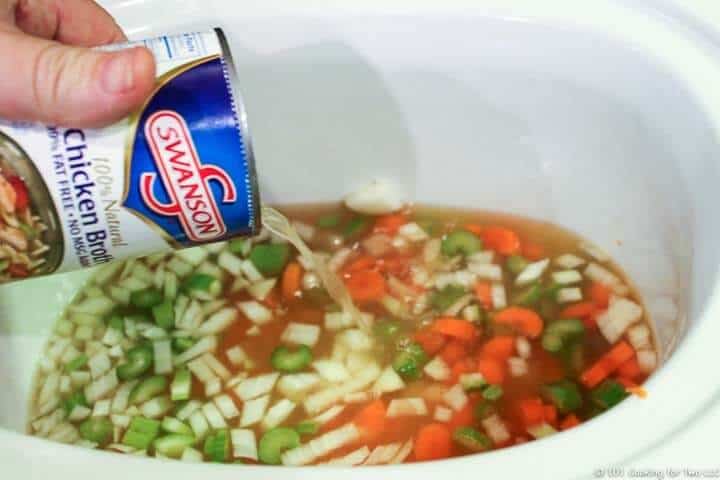 adding broth to all ingredient in crock pot