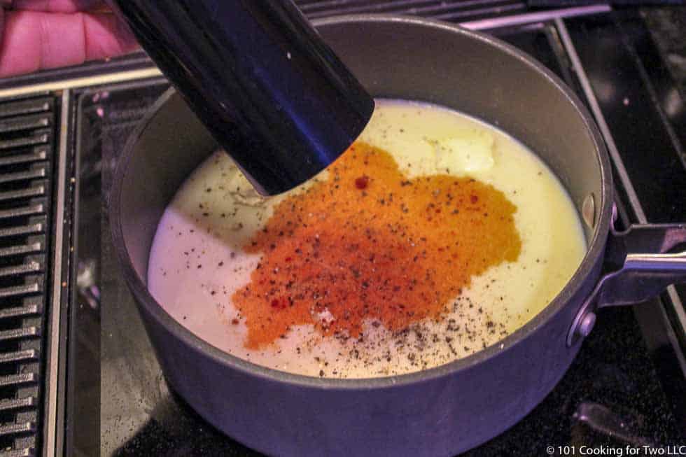 image of adding pepper to the black pan