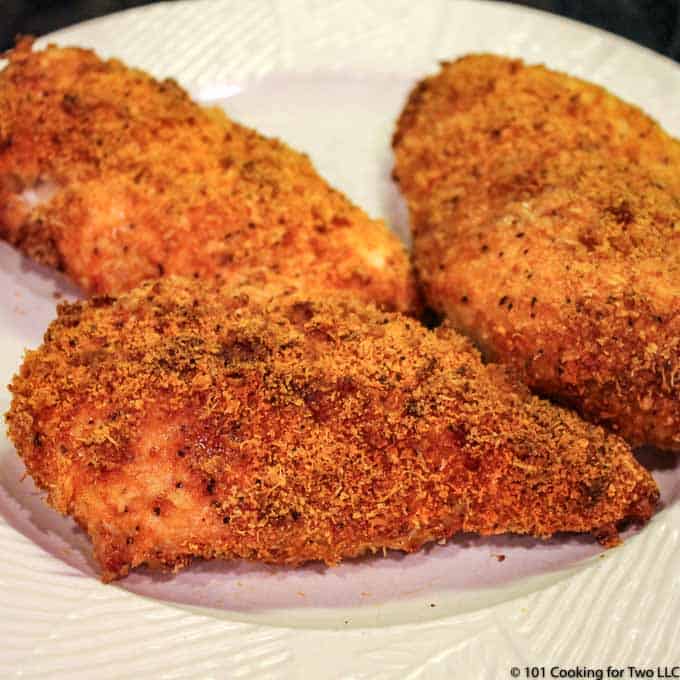Baked Parmesan Crusted Skinless Boneless Chicken Breasts on a white plate