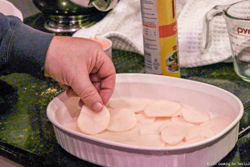 layer potatoes into dish.