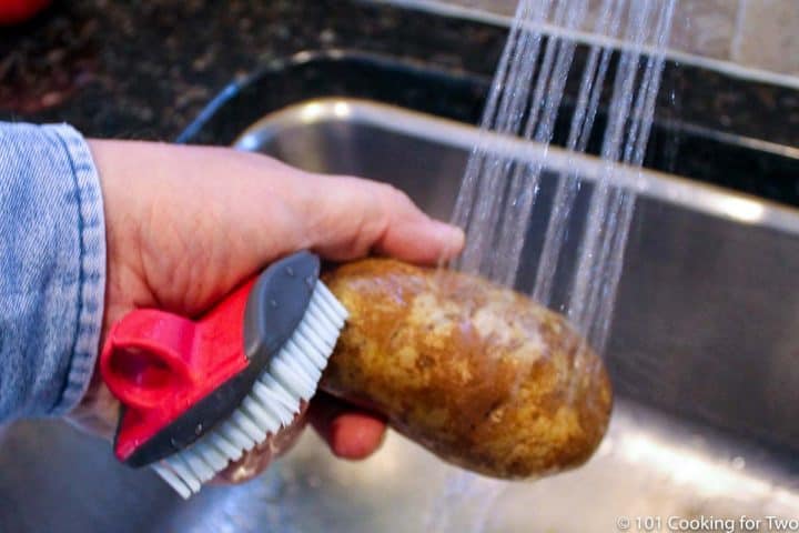 clean potato under running water.