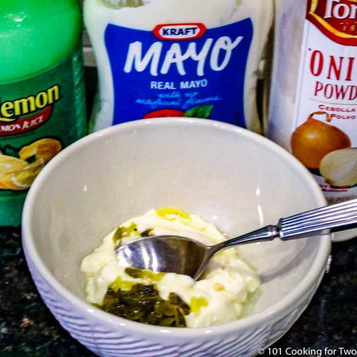 mixing tarter sauce in white bowl.